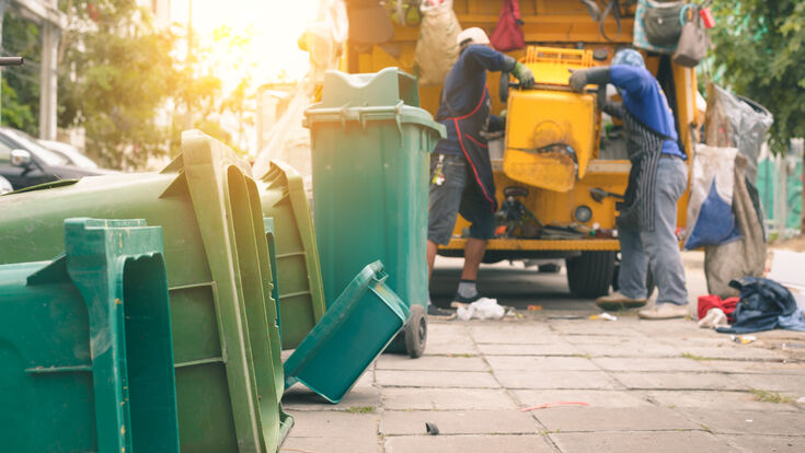 Waste removal team in Dubai loading junk into a truck