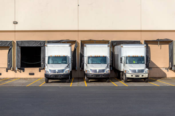 Fleet of transport trucks parked at warehouse for annual logistics contract in Dubai