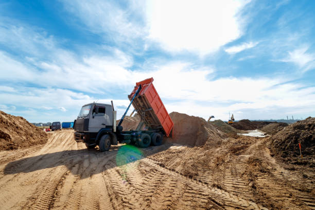 Dump truck unloading road base aggregate at a Dubai construction site
