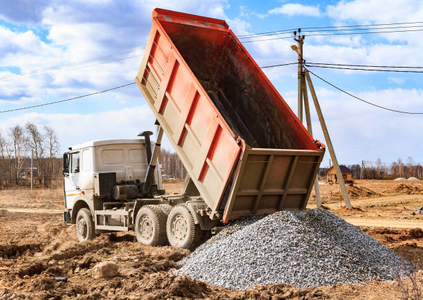 Truck unloading clean white sand at a construction site in Dubai