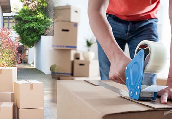 Mover packing boxes and furniture in a UAE home with professional materials