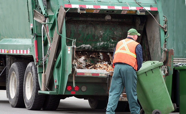 Rubbish removal team loading junk into a truck in Dubai